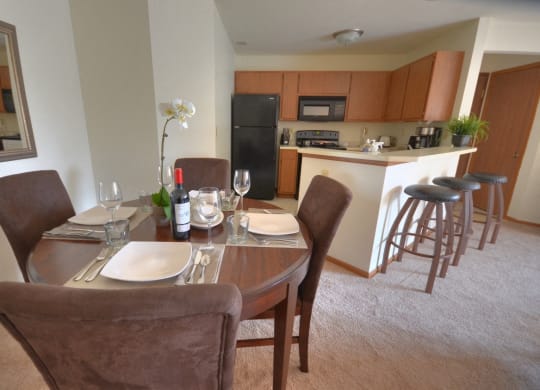 a dining room with a table and chairs and a kitchen