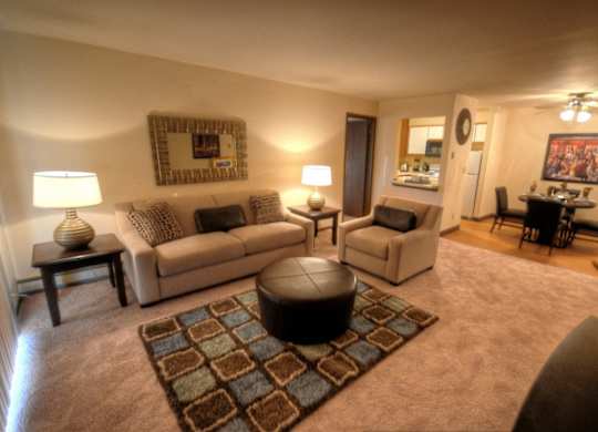 a living room with couches and chairs and a dining room table