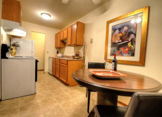 a kitchen and dining room with a table and a painting