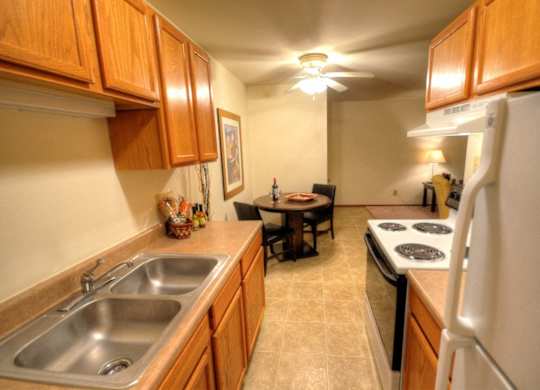 a kitchen with wooden cabinets and stainless steel appliances