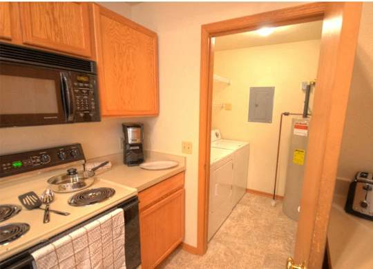 a kitchen with a stove and a refrigerator and a sink