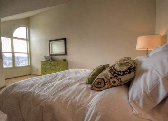 a bedroom with a large bed and a window