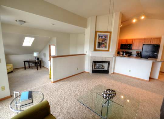 a living room with a fireplace and a glass table