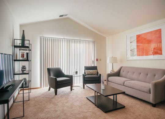 a living room with a couch and two chairs