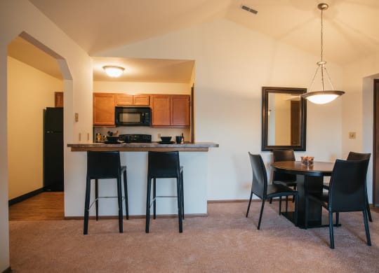 the view of a kitchen and dining area in a home