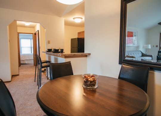a dining room and kitchen with a table and chairs and a living room with a