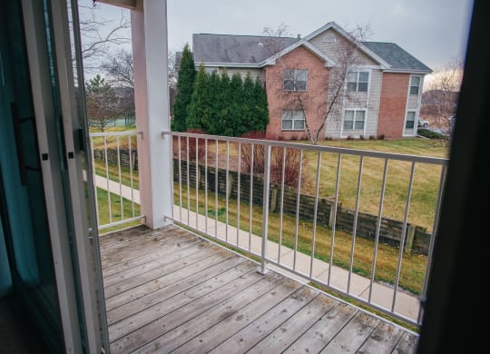 a view of a house from a balcony with a fence