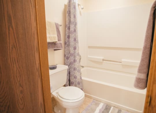 bathroom with tub, shower, toilet