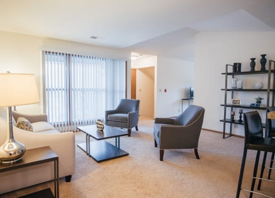 a living room with a couch and chairs and a table