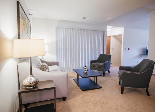a living room with a couch and chairs and a table