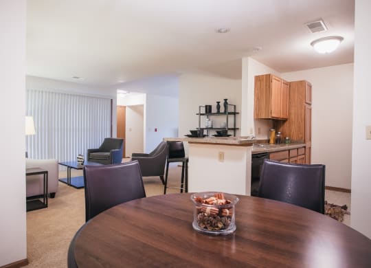 a dining room and living room with a table and chairs