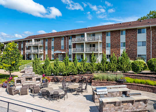 apartment community with a patio grilling area and fire place area for gathering