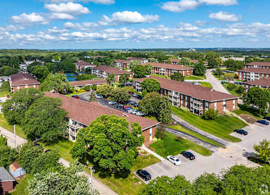 A bird's eye view of a residential area with houses and cars.