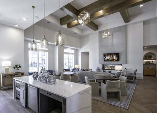 a large living room and dining room with a marble counter top