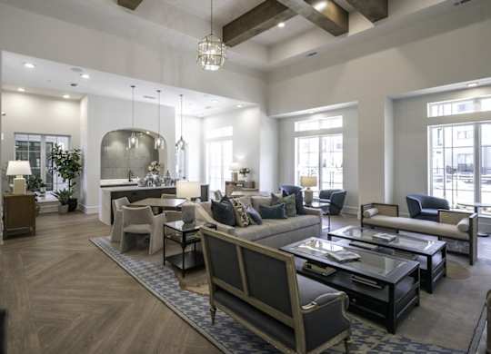 a large living room with couches and chairs