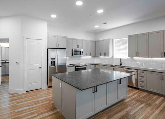 a kitchen with a large island in the middle of it