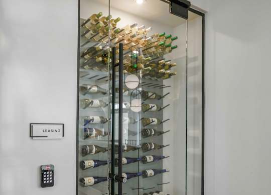 a glass wine cellar in the corner of a room
