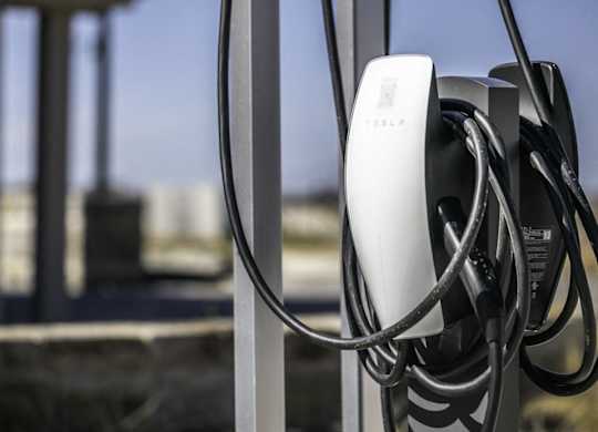 a power chord is plugged into a metal fence