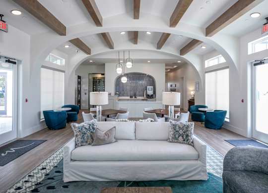 community room filled with furniture and a large windows