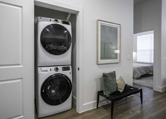 a small laundry room with a washer and dryer in a door