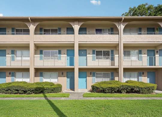 Apartment building with blue doors and windows.