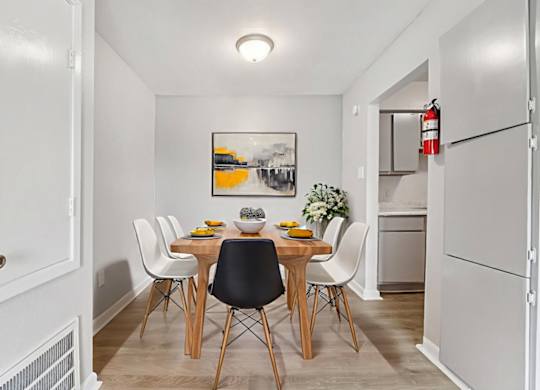 A dining room with a table set for four.