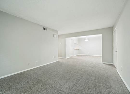 A room with a carpeted floor and white walls.