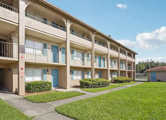 Apartment building with blue doors and windows.