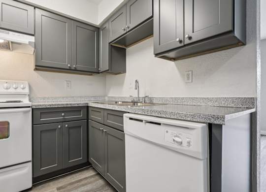 A kitchen with a white oven and a dishwasher.