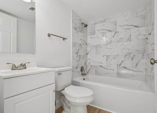 A white bathroom with a marble wallpaper.