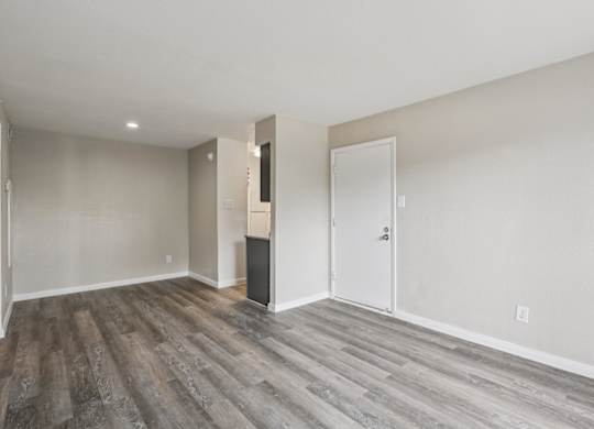 A room with a white door and a white wall.