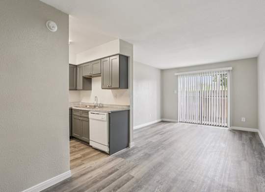 A kitchen with a white dishwasher and a white fridge.