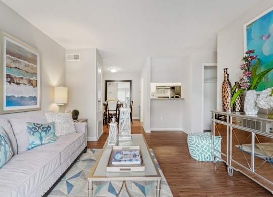 A living room with a white couch and a coffee table.
