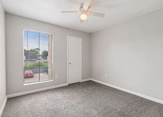 A room with a car parked outside the window.