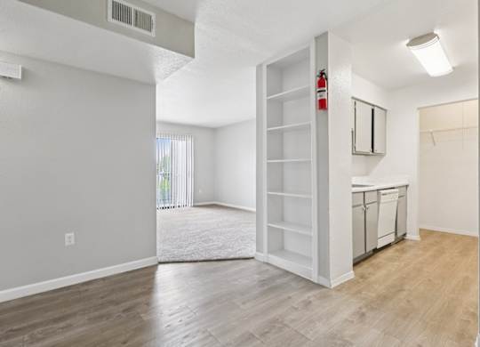A room with a white door and a window with blinds.