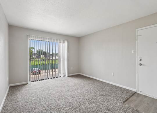 A room with a car parked outside the window.