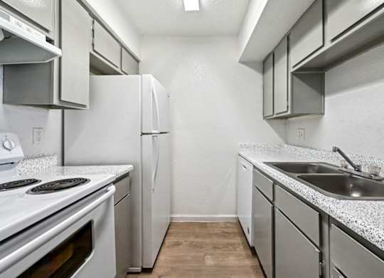 A kitchen with white appliances and a granite countertop.