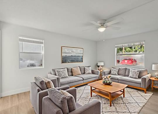 A living room with grey couches and a wooden coffee table.