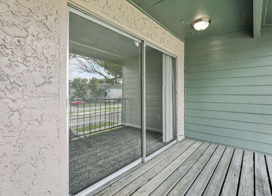 A sliding glass door opens to a deck.