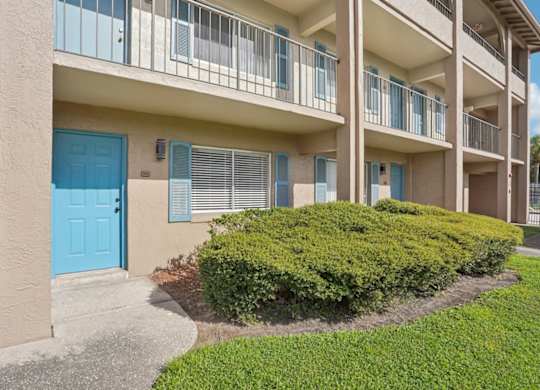 A blue door is on the left side of a building.