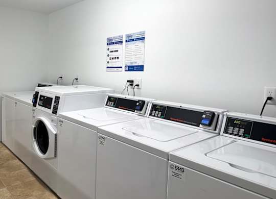 A row of washing machines and dryers at ascot place apartments