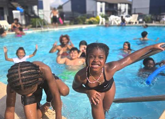 A group of people are enjoying a day at the pool.