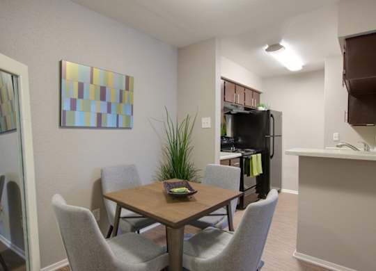 a dining room and kitchen with model furnishings in a home at Crosby at Westchase