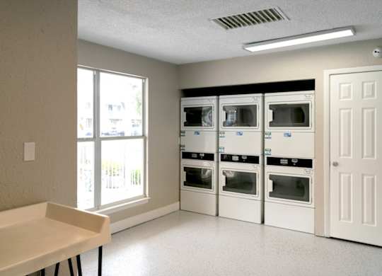 a room with a table and some microwaves in it