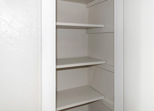 a deep linen closet with shelving