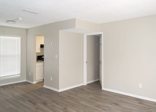 a 12th and beach living room with kitchen entrance and a doorway to the bedroom