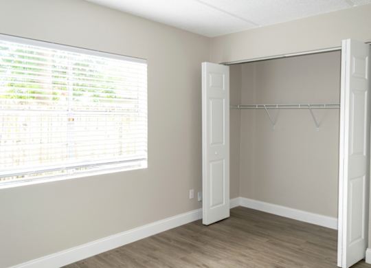 a spacious closet in a bedroom in a home at Pine Creek Apartments in South Daytona