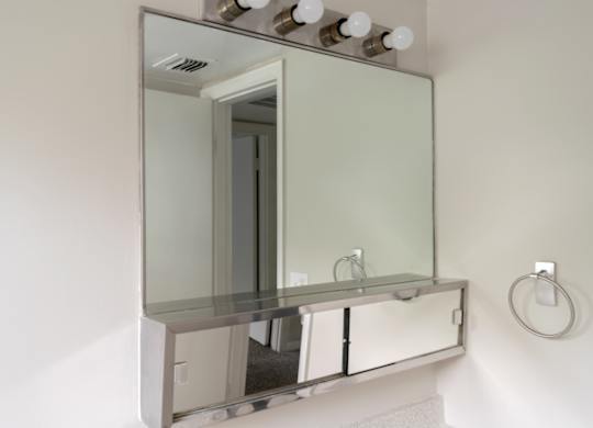 A bathroom vanity with a mirror above it.