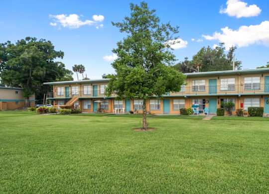 Park Apartments features a large grassy courtyard with trees throughout