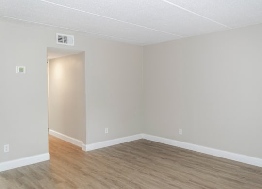 a large living room with wood-inspired flooring